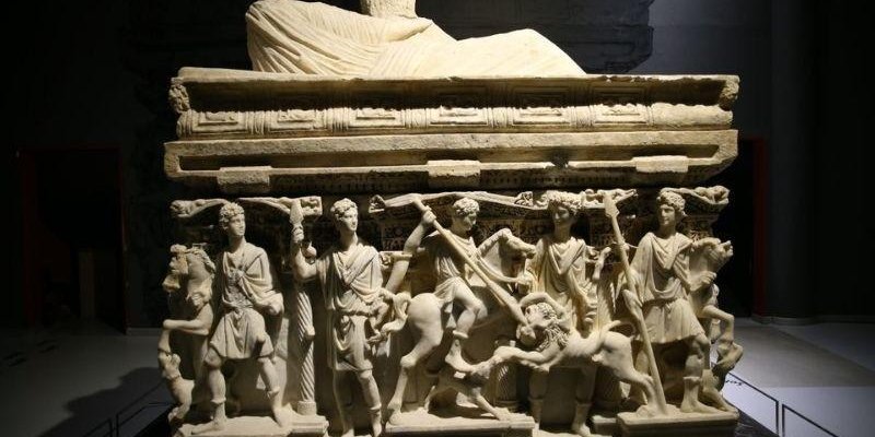 Mermerden yapılmış, kabartmalarla süslü antik bir lahit. Dikdörtgen gövdeli bu lahitin üst kısmında, baş kısmı kırılmış, örtülü bir yastığa yaslanmış yatar pozisyonda bir figür sadece vücudu örtüyle kaplı şekilde korunmuş, baş kısmı eksik. Lahitin ön yüzü tamamen yüksek kabartma heykellerle kaplı. Alt sırada altı insan figürü ile bir at veya katır benzeri hayvan, yerde diz çökmüş veya düşmüş bir figür. Soldan sağa doğru, uzun tunik veya mantolar giymiş, bazısı sakallı bazısı genç yüzlü erkek fig